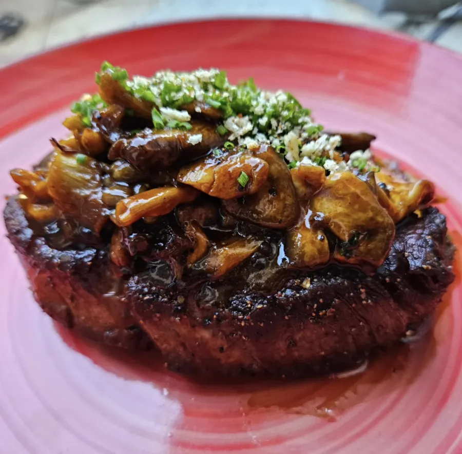 Seared steak with wild mushroom sauce and herbs