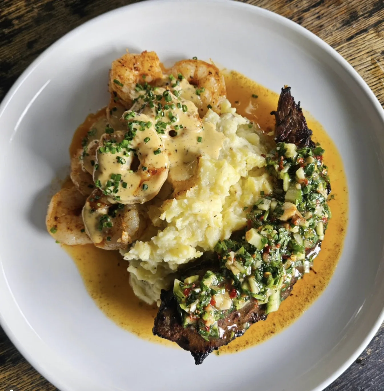 Surf and turf — seared steak with shrimp, mashed potatoes and chimichurri